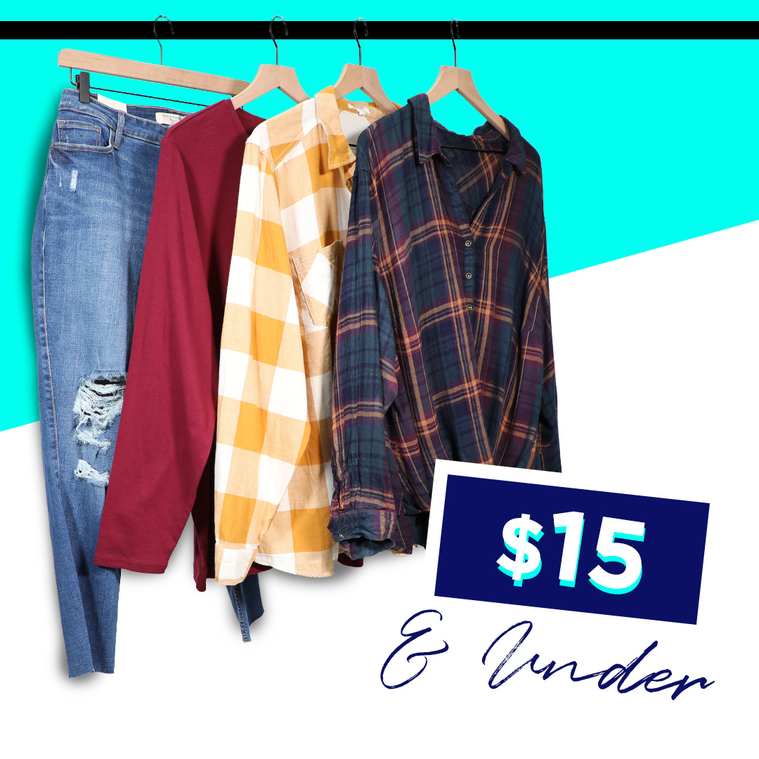 Blouses and a pair of jeans on a clothing rack