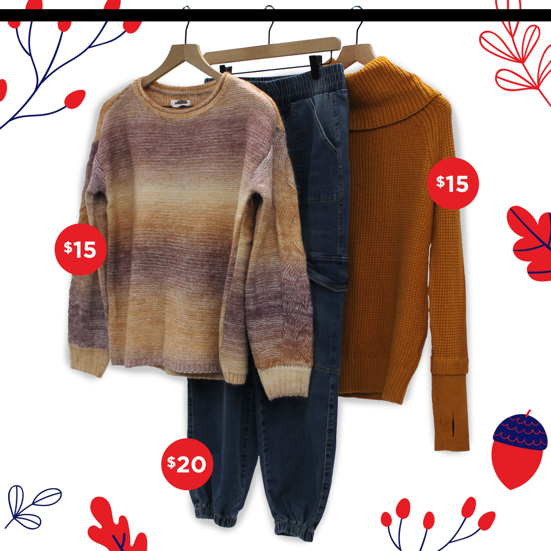 Womens fall clothes on clothing hanger, two sweaters and a pair of jeans