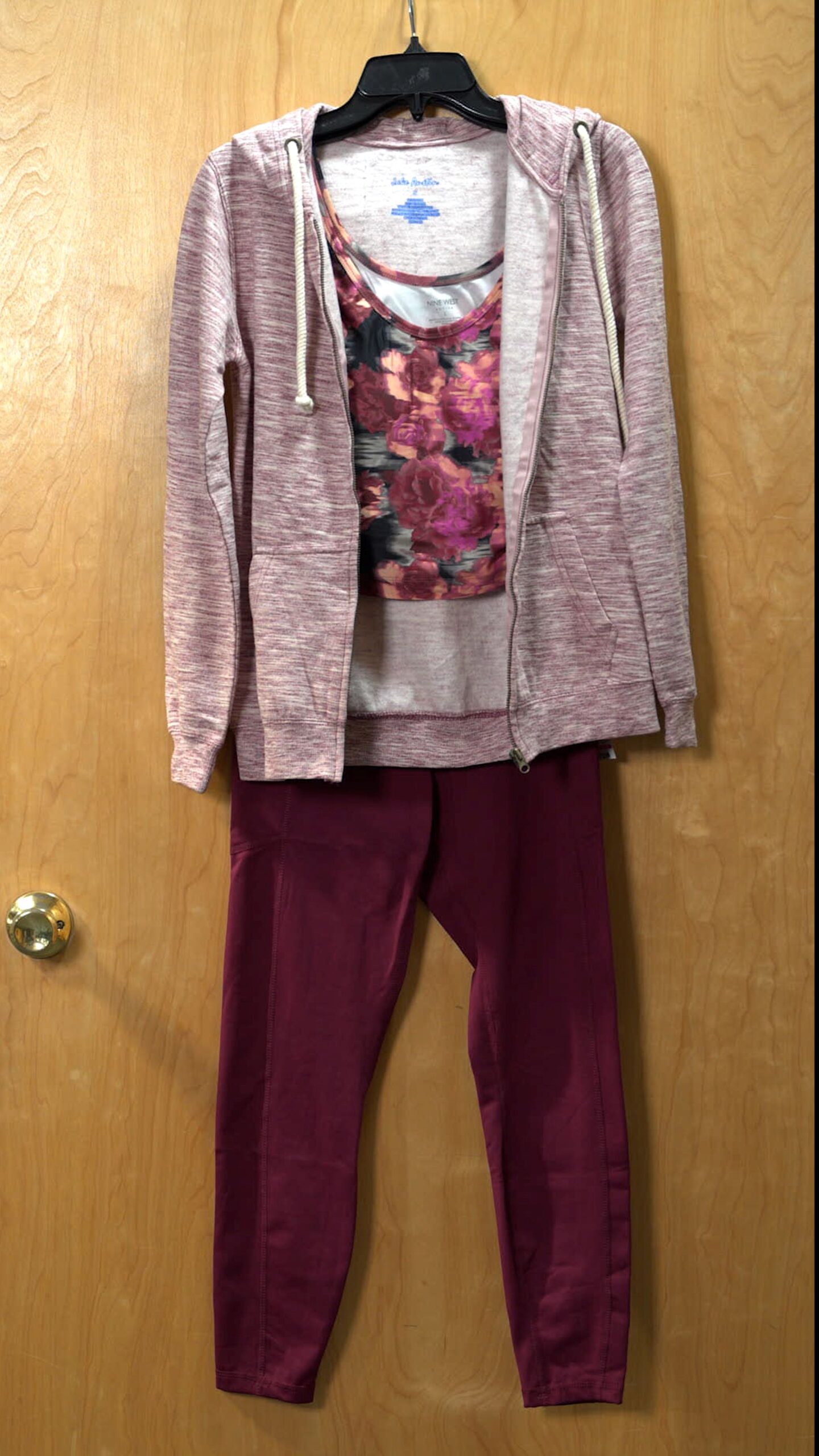 Photo of activewear outfit hanging on a door
