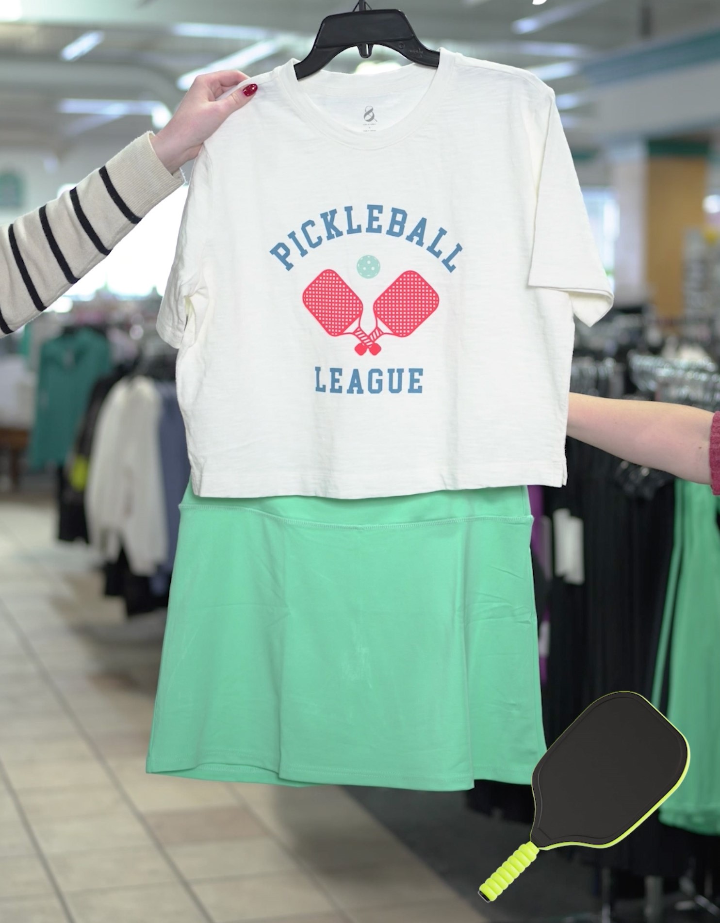 Image of a shirt with pickleball paddles and a teal skirt